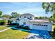 Charming two-story home with a well-maintained lawn, beautiful landscaping, and attached two-car garage at 2816 Fairmount Ave, Lakeland, FL 33803