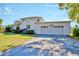 Spacious two-car garage with stylish doors, an adjacent lawn, and beautiful landscaping at 2816 Fairmount Ave, Lakeland, FL 33803