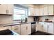 Bright kitchen with white cabinets, stainless steel appliances, subway tile backsplash, and granite countertops at 2816 Fairmount Ave, Lakeland, FL 33803
