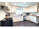Bright kitchen featuring white cabinetry, stainless steel appliances, subway tile backsplash, and a large window at 2816 Fairmount Ave, Lakeland, FL 33803