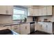 Bright kitchen featuring white cabinets, stainless steel appliances, granite countertops, and lots of natural light at 2816 Fairmount Ave, Lakeland, FL 33803