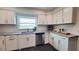 Bright kitchen featuring white cabinets, stainless steel appliances, granite countertops, and a stainless steel dishwasher at 2816 Fairmount Ave, Lakeland, FL 33803