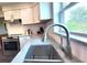 Close-up of the kitchen sink, faucet, granite countertops, and stainless steel appliances at 2816 Fairmount Ave, Lakeland, FL 33803