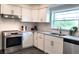 Updated kitchen featuring stainless steel appliances, white cabinets, subway tile, and dark flooring at 2816 Fairmount Ave, Lakeland, FL 33803