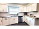 Bright kitchen with white cabinets, stainless steel appliances, subway tile backsplash, and dark flooring at 2816 Fairmount Ave, Lakeland, FL 33803