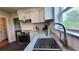 Updated kitchen featuring white cabinets, granite countertops, stainless steel appliances, and large sink at 2816 Fairmount Ave, Lakeland, FL 33803