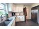 Updated kitchen with stainless steel appliances, white cabinets, granite countertops, and dark flooring at 2816 Fairmount Ave, Lakeland, FL 33803