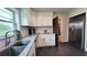Updated kitchen featuring white cabinets, stainless steel appliances, granite countertops and a modern refrigerator at 2816 Fairmount Ave, Lakeland, FL 33803