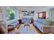 Bright living room with hardwood floors, plantation shutters, and comfortable seating at 2816 Fairmount Ave, Lakeland, FL 33803