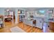 Cozy living room with hardwood floors, a charming drop-leaf table and lots of natural light at 2816 Fairmount Ave, Lakeland, FL 33803
