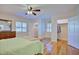 Sunny main bedroom with hardwood floors, shutters on the windows, a ceiling fan, and a walk-in closet at 2816 Fairmount Ave, Lakeland, FL 33803