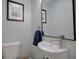 Stylish powder room includes a floating sink, unique faucet, framed artwork, and a modern design at 2816 Fairmount Ave, Lakeland, FL 33803