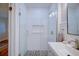 Beautifully renovated bathroom features a walk-in shower with glass doors, subway tile, and modern fixtures at 2816 Fairmount Ave, Lakeland, FL 33803