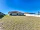 Spacious backyard with green grass and a white fence at 2929 Flying Blackbird Rd, Bartow, FL 33830