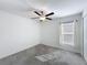 Cozy bedroom with a ceiling fan, carpet flooring, and a bright window with blinds at 2929 Flying Blackbird Rd, Bartow, FL 33830