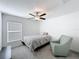 Relaxing bedroom with a ceiling fan, single bed, and an accent chair at 2929 Flying Blackbird Rd, Bartow, FL 33830