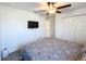 Comfortable bedroom with ceiling fan and mounted TV at 2929 Flying Blackbird Rd, Bartow, FL 33830