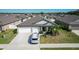 Inviting home featuring a three-car garage, well-manicured lawn, and a welcoming entrance at 2929 Flying Blackbird Rd, Bartow, FL 33830