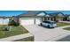 A view of the home, highlighting its three-car garage and well-maintained front lawn at 2929 Flying Blackbird Rd, Bartow, FL 33830