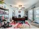 Bright home office with wood desk, chair, and bookshelves, perfect for working from home at 2929 Flying Blackbird Rd, Bartow, FL 33830