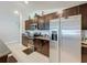 A view of the kitchen with dark cabinets, stainless steel appliances, and granite countertops at 2929 Flying Blackbird Rd, Bartow, FL 33830