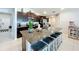 Kitchen with center island featuring bar stool seating, dark cabinets, and stainless steel appliances at 2929 Flying Blackbird Rd, Bartow, FL 33830