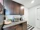 Granite kitchen counter with dark cabinets, stainless steel appliances, and tile flooring at 2929 Flying Blackbird Rd, Bartow, FL 33830