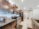 Kitchen featuring dark cabinetry, stainless appliances, granite counters, and tile flooring at 2929 Flying Blackbird Rd, Bartow, FL 33830