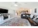 Spacious living room open to the kitchen, featuring a large sectional sofa and tile flooring at 2929 Flying Blackbird Rd, Bartow, FL 33830