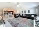Bright and airy living room adjacent to the kitchen, complete with a large leather sectional and tile floors at 2929 Flying Blackbird Rd, Bartow, FL 33830