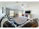 Open living room boasts a large sectional sofa, tile flooring, and a stylish entertainment center at 2929 Flying Blackbird Rd, Bartow, FL 33830