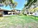 Large backyard with lush grass, various trees, a brick patio and a shed at 302 Luna Rd, Auburndale, FL 33823
