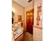 Bathroom featuring a retro-style vanity, and towel bar, next to wood-paneled door at 302 Luna Rd, Auburndale, FL 33823