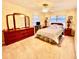 Bedroom with neutral carpet, ceiling fan and a dresser with a three-part mirror at 302 Luna Rd, Auburndale, FL 33823