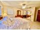 Bedroom with a ceiling fan, carpet, dresser with mirror and a bed with decorative pillows at 302 Luna Rd, Auburndale, FL 33823