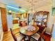 Well-lit kitchen adjacent to dining room with a chandelier at 302 Luna Rd, Auburndale, FL 33823