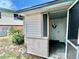 Enclosed entryway with storm door and a view to the backyard at 302 Luna Rd, Auburndale, FL 33823