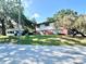 Charming two-story home with well-maintained lawn and mature trees in a residential neighborhood at 302 Luna Rd, Auburndale, FL 33823