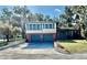 Charming two-story home with a well-maintained front yard and a two-car garage at 302 Luna Rd, Auburndale, FL 33823
