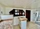 Functional kitchen with white cabinets and an adjacent bar area at 302 Luna Rd, Auburndale, FL 33823