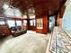 Inviting living room with a comfortable sofa, wood paneling, and tiled bar countertop at 302 Luna Rd, Auburndale, FL 33823