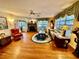 Cozy living room featuring hardwood floors, a fireplace, and plenty of natural light at 302 Luna Rd, Auburndale, FL 33823