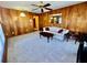 Living room features wood paneling, decorative mirror, and cozy seating area at 302 Luna Rd, Auburndale, FL 33823