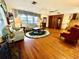 Bright and airy living room with hardwood floors, large windows, and comfortable seating at 302 Luna Rd, Auburndale, FL 33823