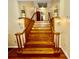 Grand staircase features wood railing and lights leading to the second level hallway at 302 Luna Rd, Auburndale, FL 33823
