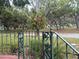 Lawn view of yard and tree in the neighborhood with decorative metal fence at 302 Luna Rd, Auburndale, FL 33823