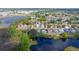 Aerial view of a residential neighborhood near a lake, highlighting the property's location at 307 Balmoral Ct, Davenport, FL 33896