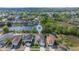 Aerial view of a home nestled in a residential area with a nearby pond and lush greenery at 307 Balmoral Ct, Davenport, FL 33896