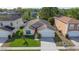 Overhead view of a single Gathering home with manicured front lawn, nearby pond and neighborhood at 307 Balmoral Ct, Davenport, FL 33896