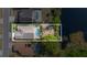 Drone eye view of property backing up to a pond and highlighting screened in pool at 307 Balmoral Ct, Davenport, FL 33896